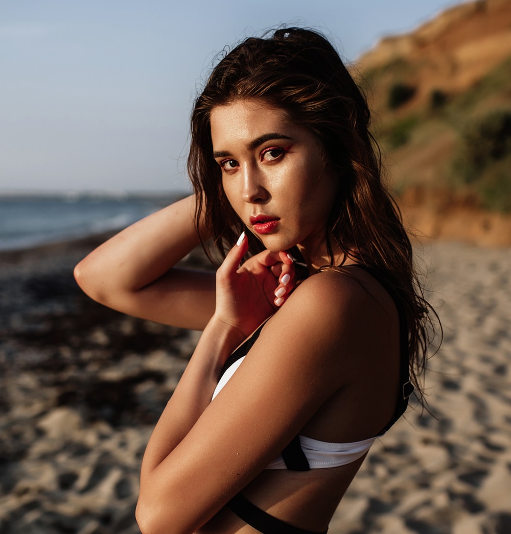 a woman sitting at a beach