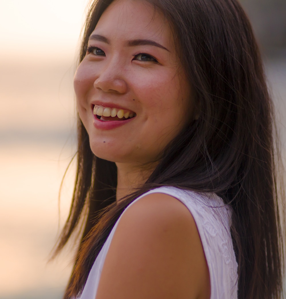 a woman smiling with clear skin